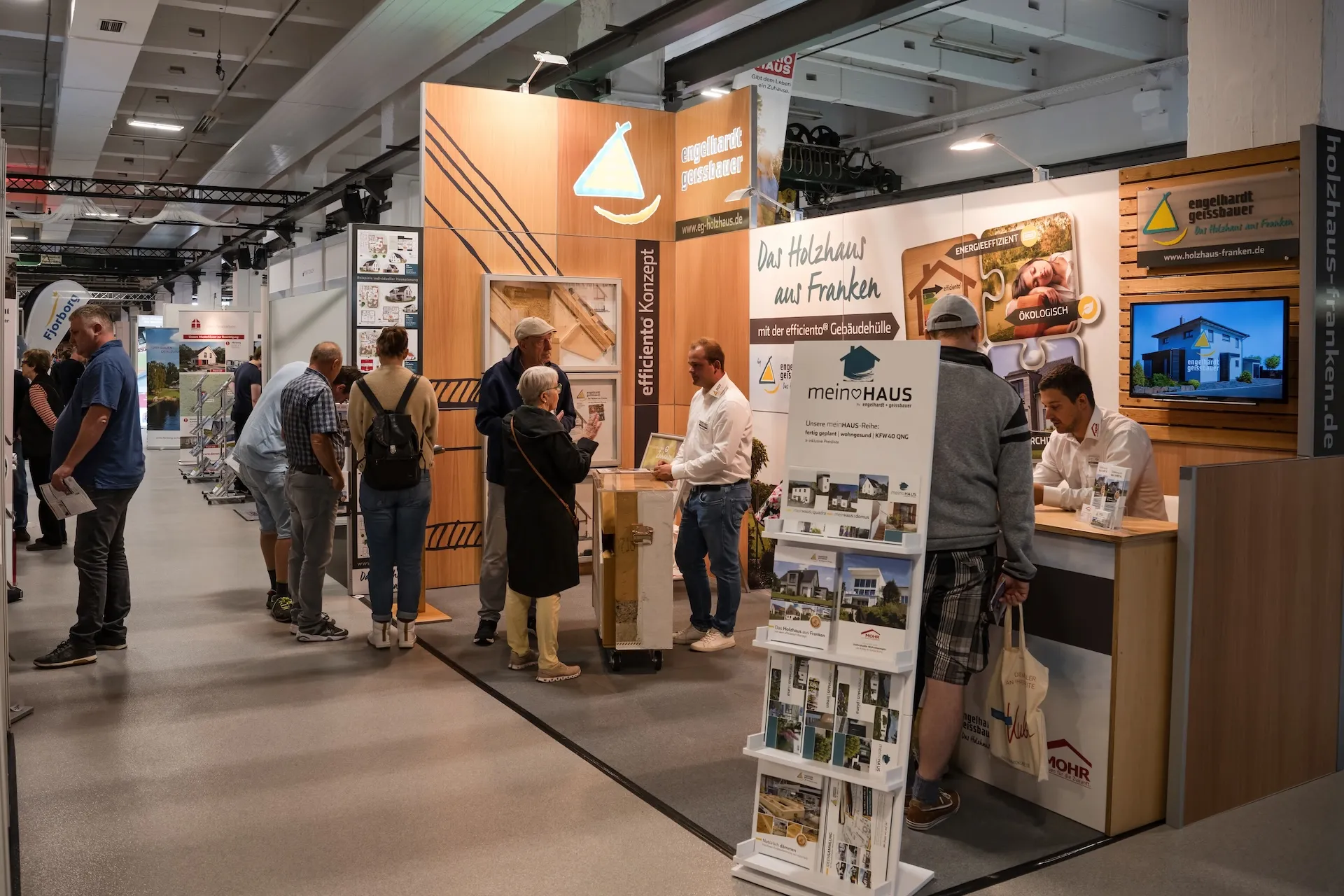Trade fair booth by Holzhaus Franken, architecture and materials emphasized in the image.