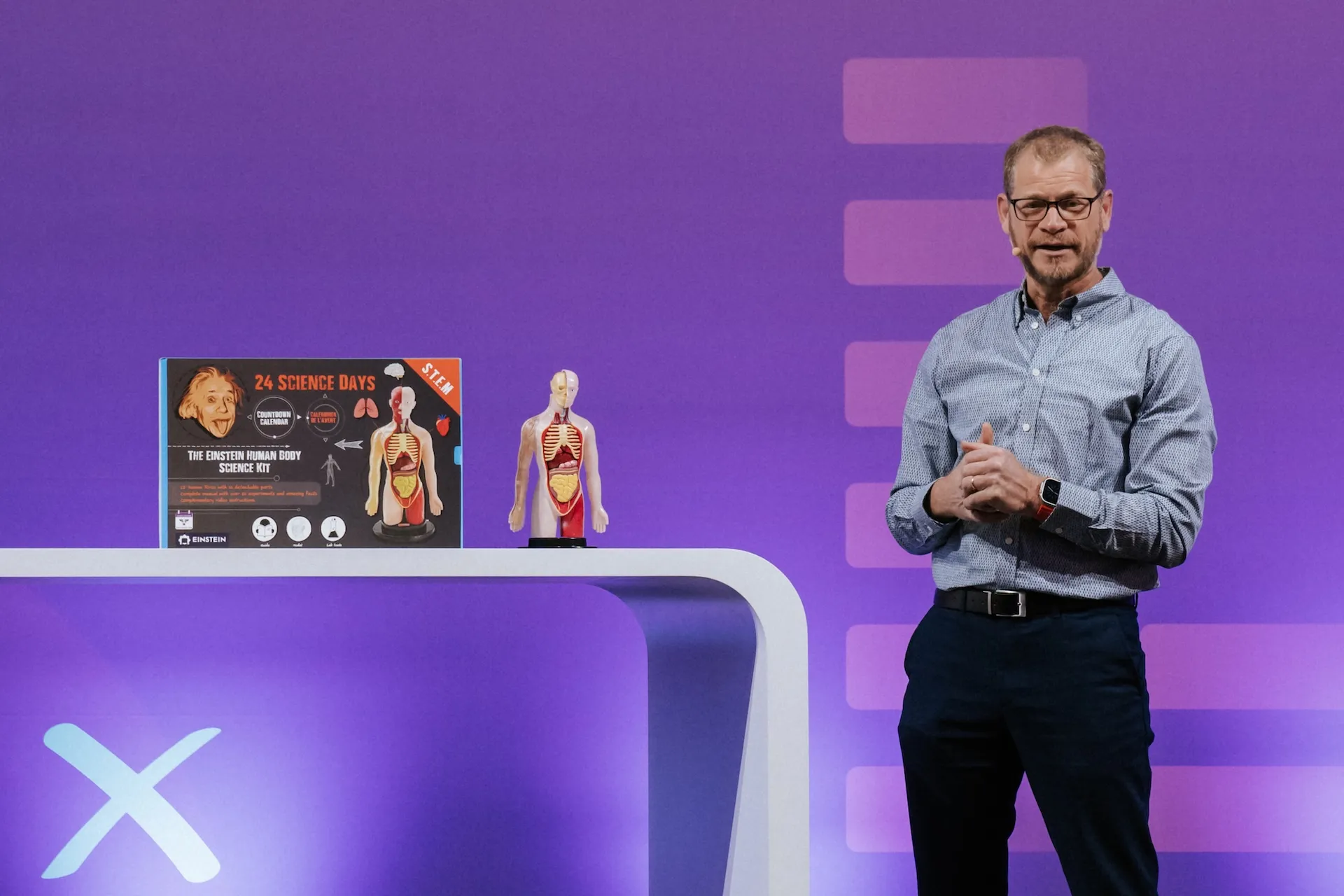 Live presentation on a trade fair stage, emotional moment captured.