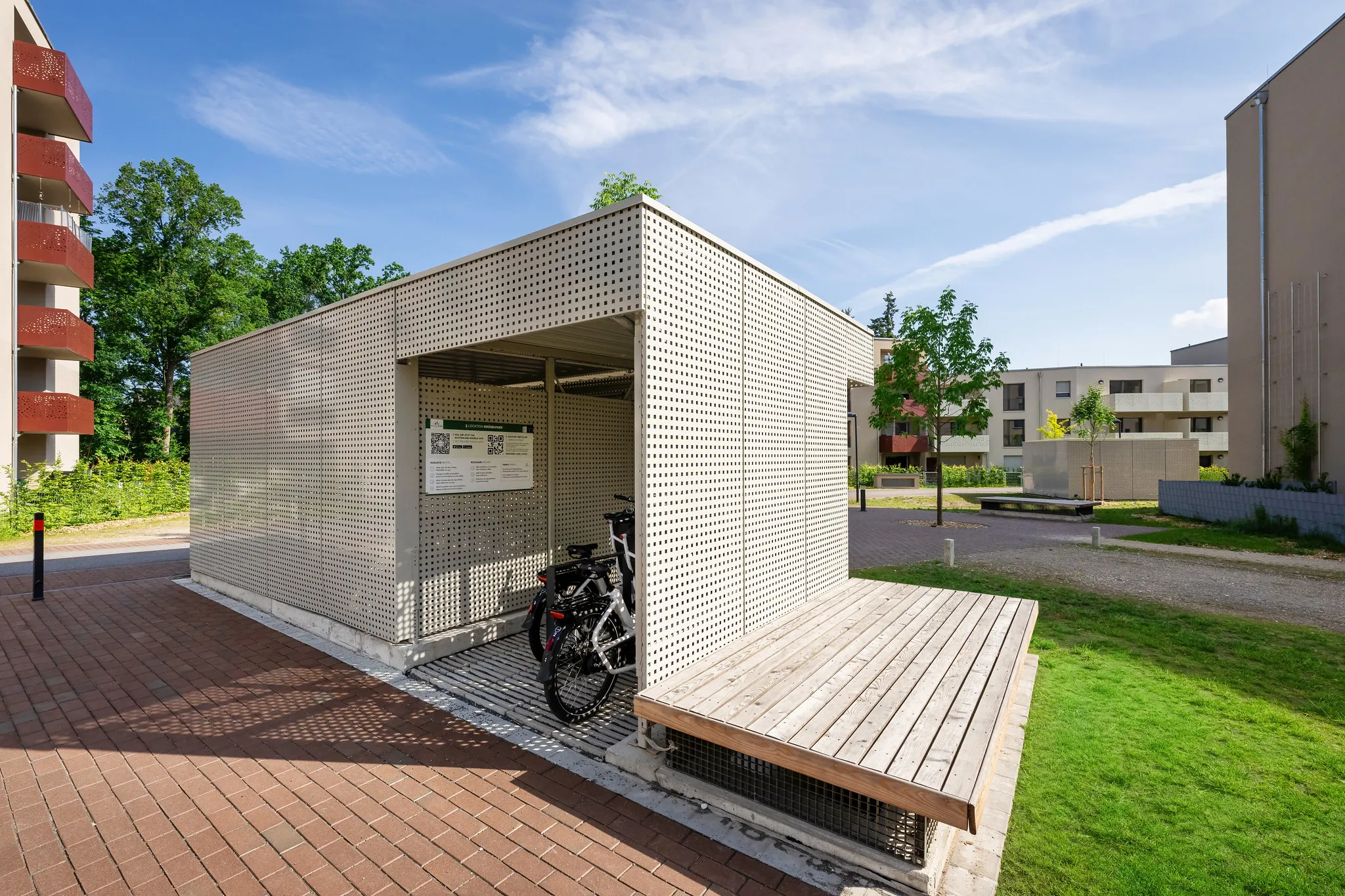 Überdachter Fahrradunterstand mit perforierter Metallfassade.