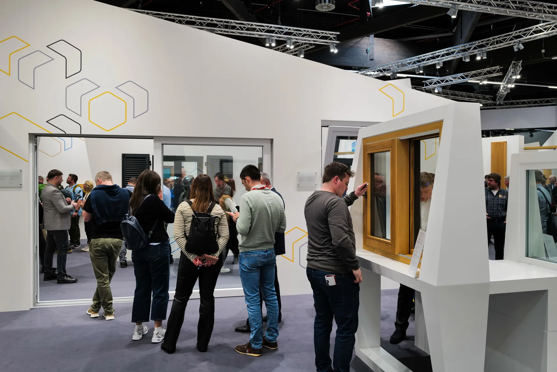 Booth with window and frame exhibits and trade visitors