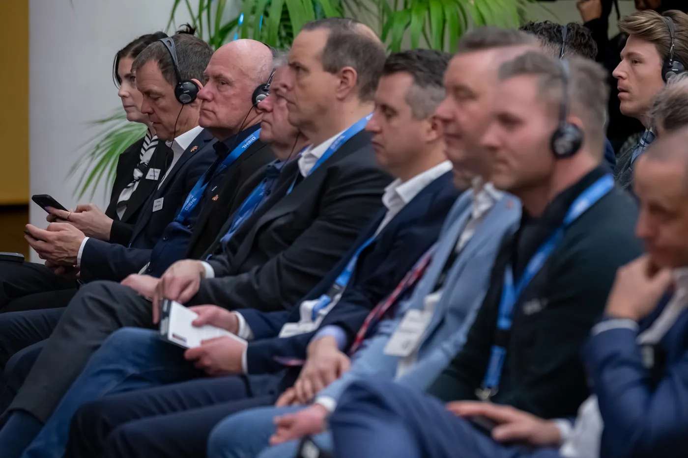 Conference audience with headsets in the front row