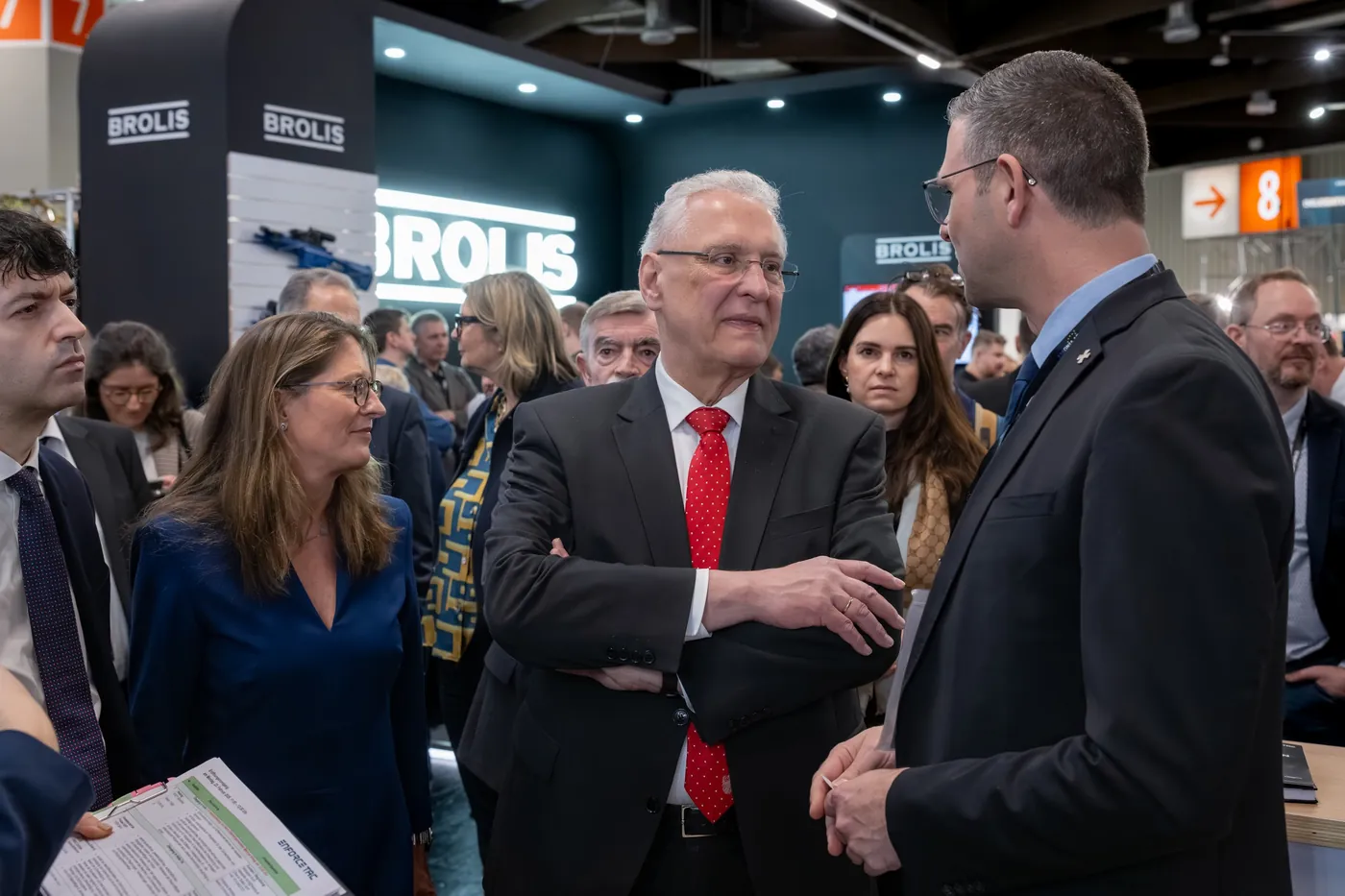 Political visitor in conversation at a booth at Enforce Tac in Nuremberg