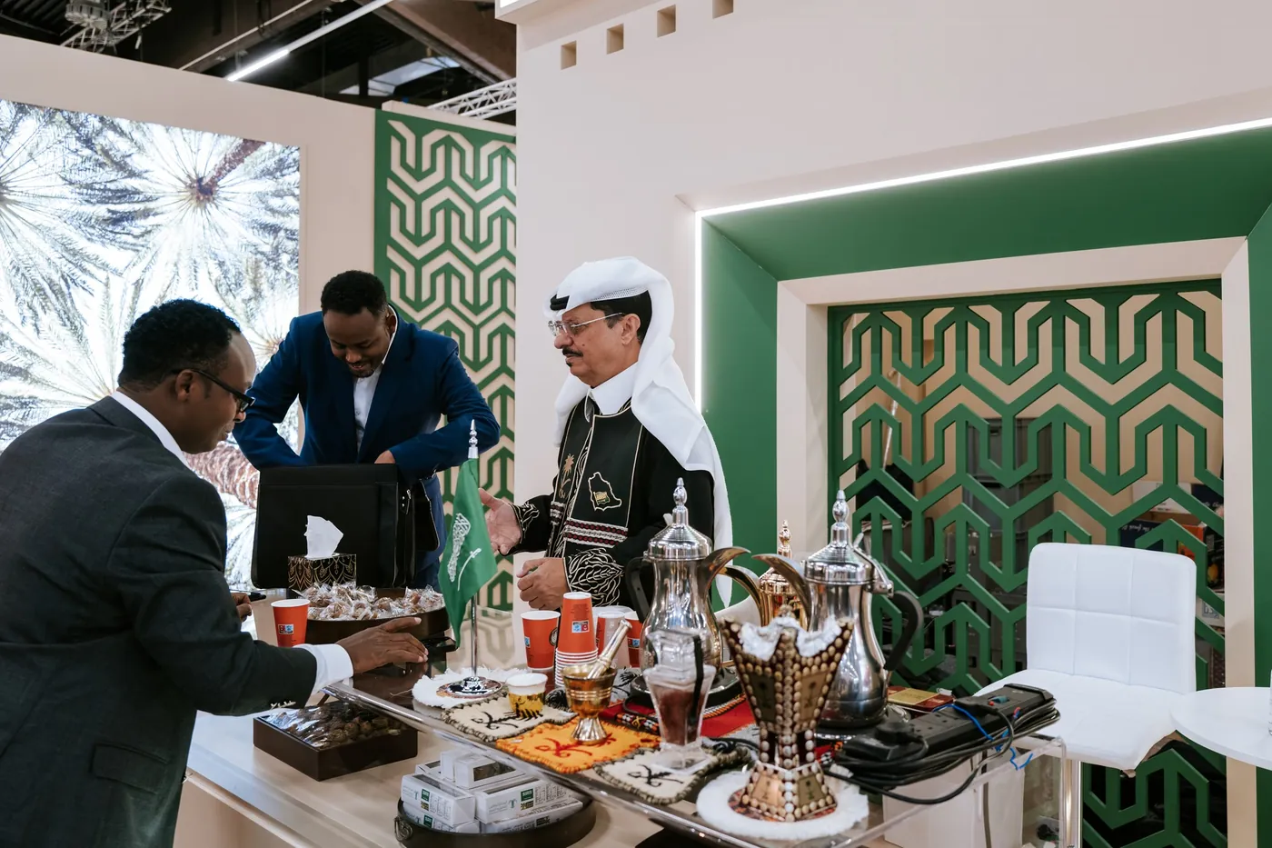 Host serving tea and pastries at a booth at BIOFACH in Nuremberg