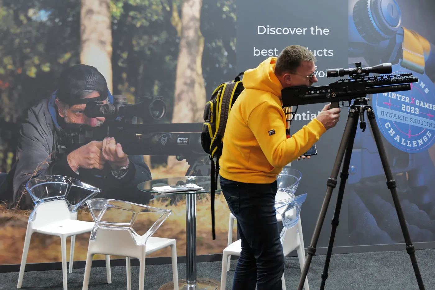 Visitor testing optics on a tripod at IWA OutdoorClassics in Nuremberg