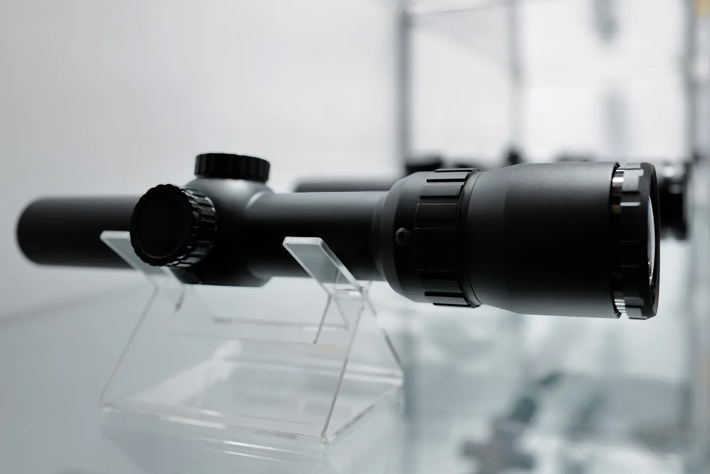 Riflescope on an acrylic stand as an exhibit, product detail at IWA OutdoorClassics in Nuremberg